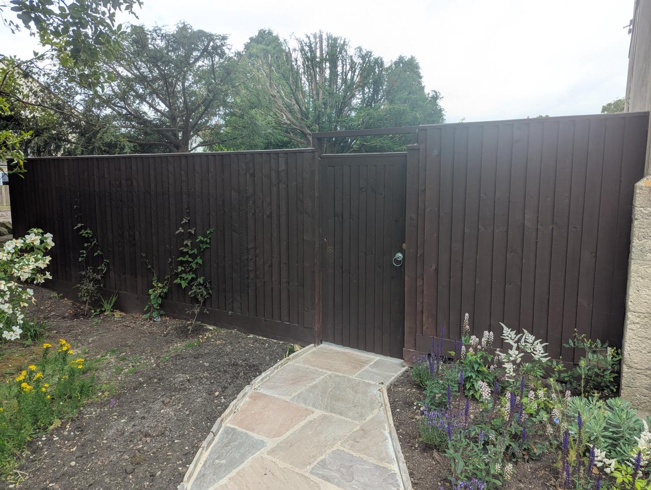 Finished closeboard fence and gate with new stone path by Perry's All Outdoor Solutions
